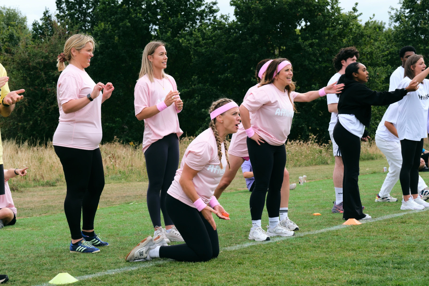 Pink team cheering on the sidelines