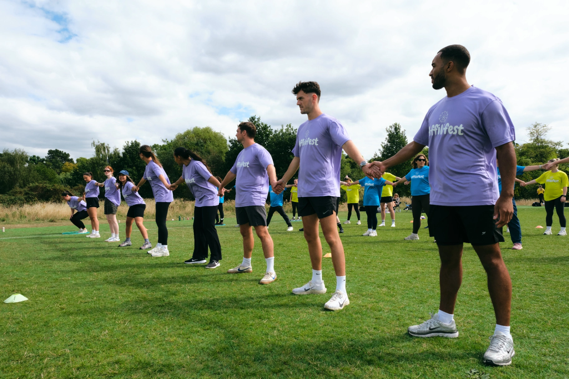 Purple team lined up holding hands during the opening ceremony